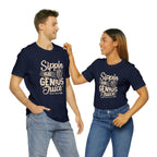 Smiling man and woman standing side by side, both wearing navy short-sleeve T-shirts printed with the slogan “Sippin on Genius Juice” and stylized coffee to-go cup graphics, shown against a plain white background.