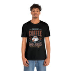 Adult man modeling a black short-sleeve T-shirt featuring the “Fueled by Coffee and Dad Jokes” graphic with a coffee cup illustration and Rock Creek Coffee text, shown against a plain white background.