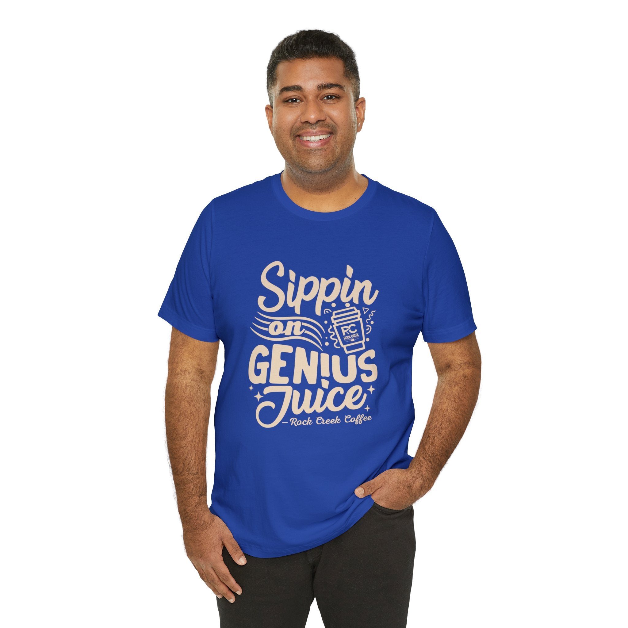 Man modeling a royal blue short-sleeve T-shirt printed with a coffee-themed slogan “Sippin on Genius Juice” and a stylized to-go cup graphic on the front, shown against a white background.