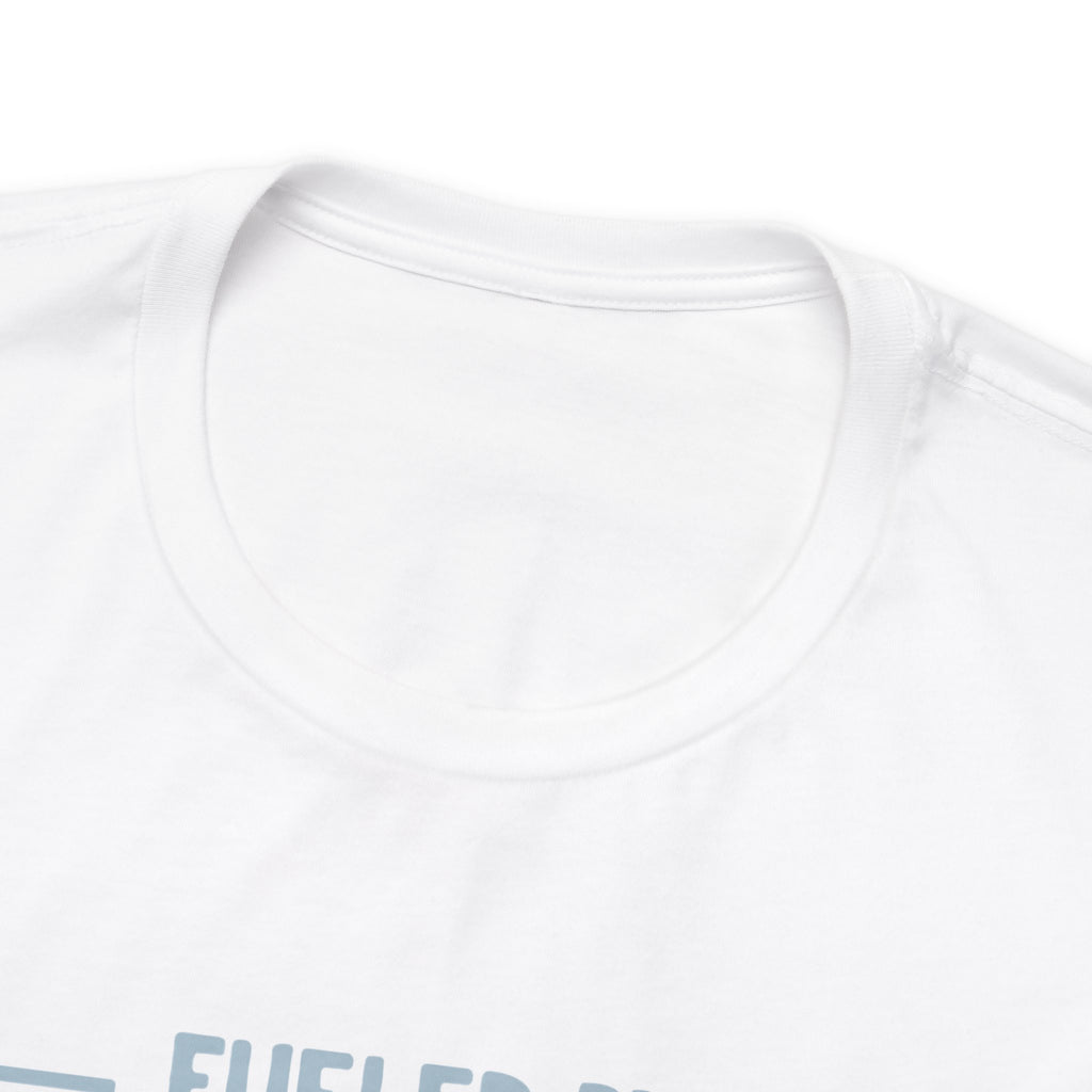 Close-up detail of a white crew neck T-shirt showing the neckline and upper chest area, with the top edge of the “Fueled by Coffee and Dad Jokes” graphic partially visible against a plain white background.