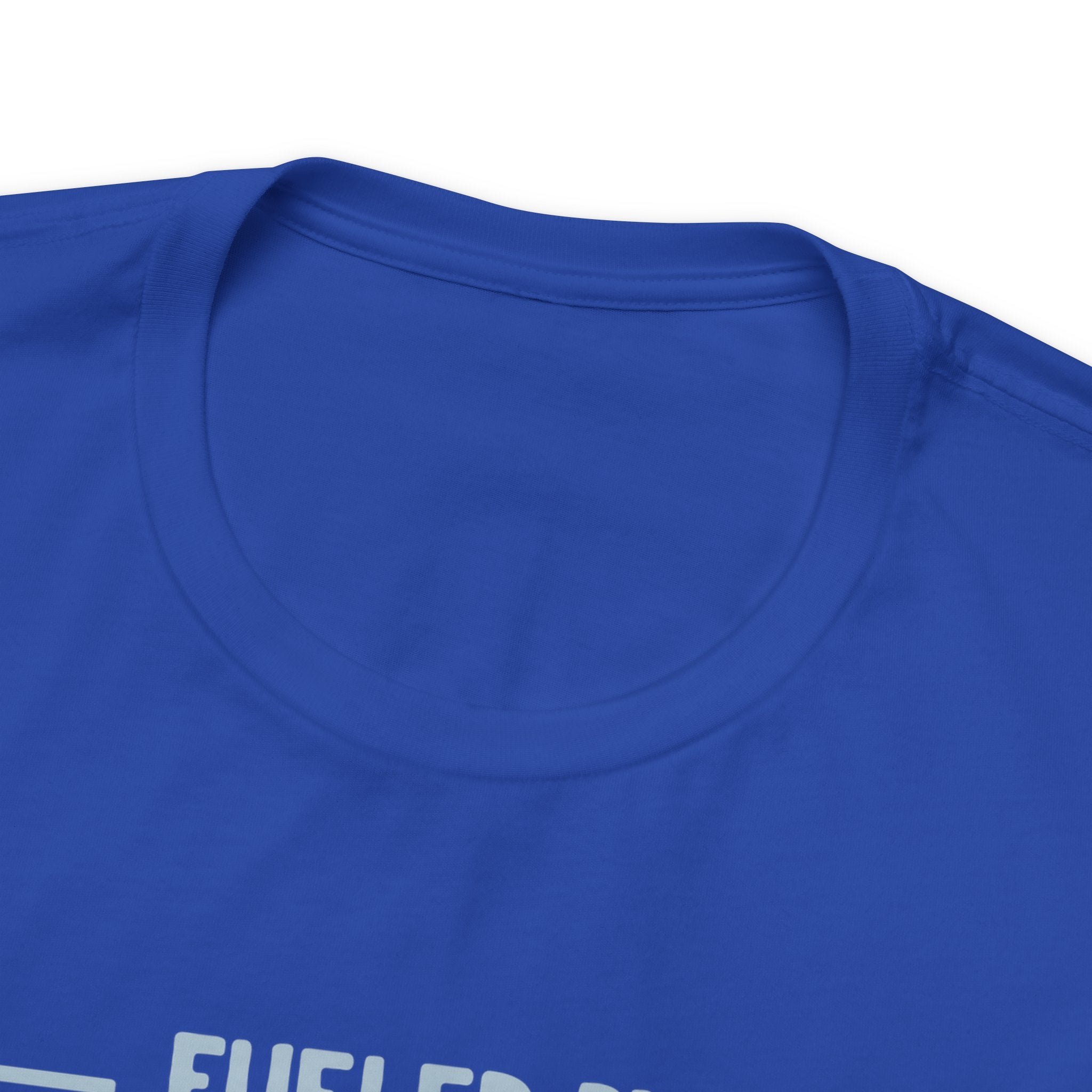 Close-up detail of a royal blue crew neck T-shirt showing the neckline and upper chest area, with the top edge of the “Fueled by Coffee and Dad Jokes” graphic partially visible against a plain white background.
