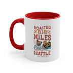White ceramic coffee mug with a red interior and handle featuring the Roasted 818 Miles East of Seattle Rock Creek Coffee design in red, blue, and brown lettering with a coffee cup and mountain illustration.