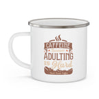 White enamel-style coffee mug with silver rim and side handle, featuring the phrase “Caffeine Because Adulting Is Hard – Rock Creek Coffee” in brown and tan lettering, displayed against a white background.