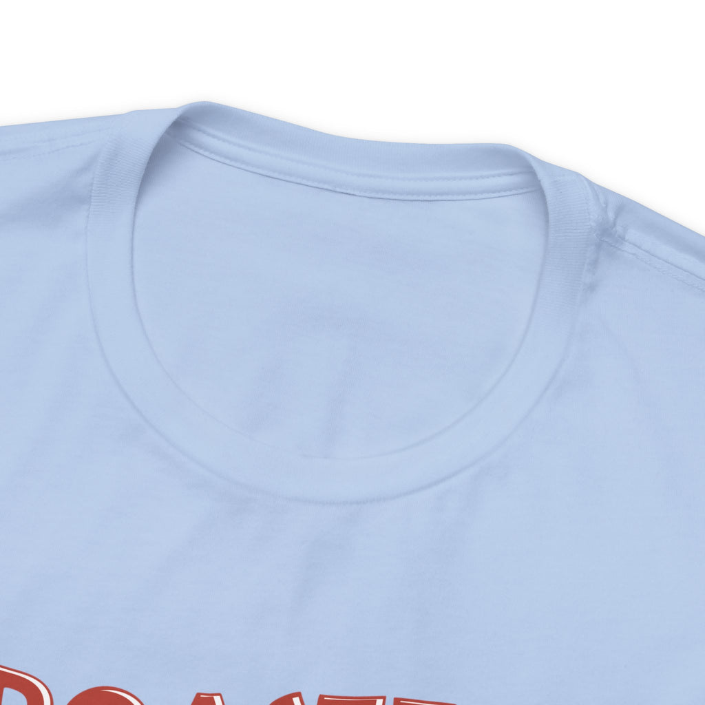 Close-up of a light blue Seattle coffee graphic T-shirt featuring the top of the “Roasted 818 Miles East of Seattle” design on a plain white background.