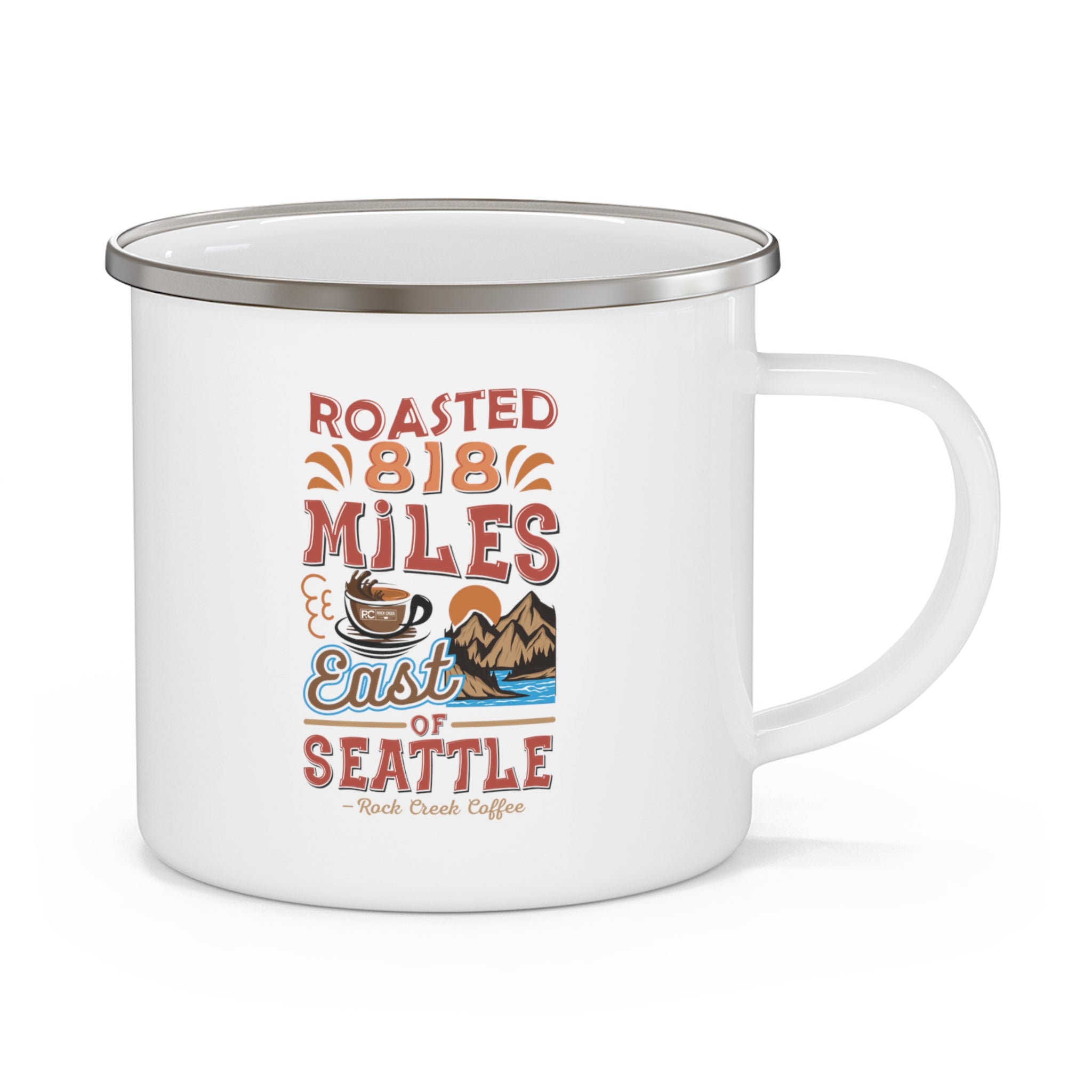 White enamel-style coffee mug with silver rim and handle featuring a colorful “Roasted 818 Miles East of Seattle - Rock Creek Coffee” design with a coffee cup and mountain illustration, displayed against a white background.