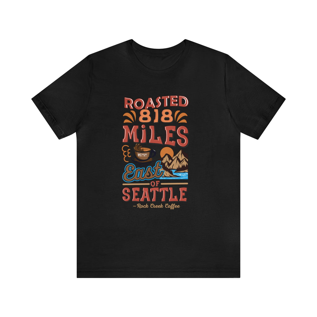 Black Seattle coffee graphic T-shirt with “Roasted 818 Miles East of Seattle” design, shown against a plain white background.