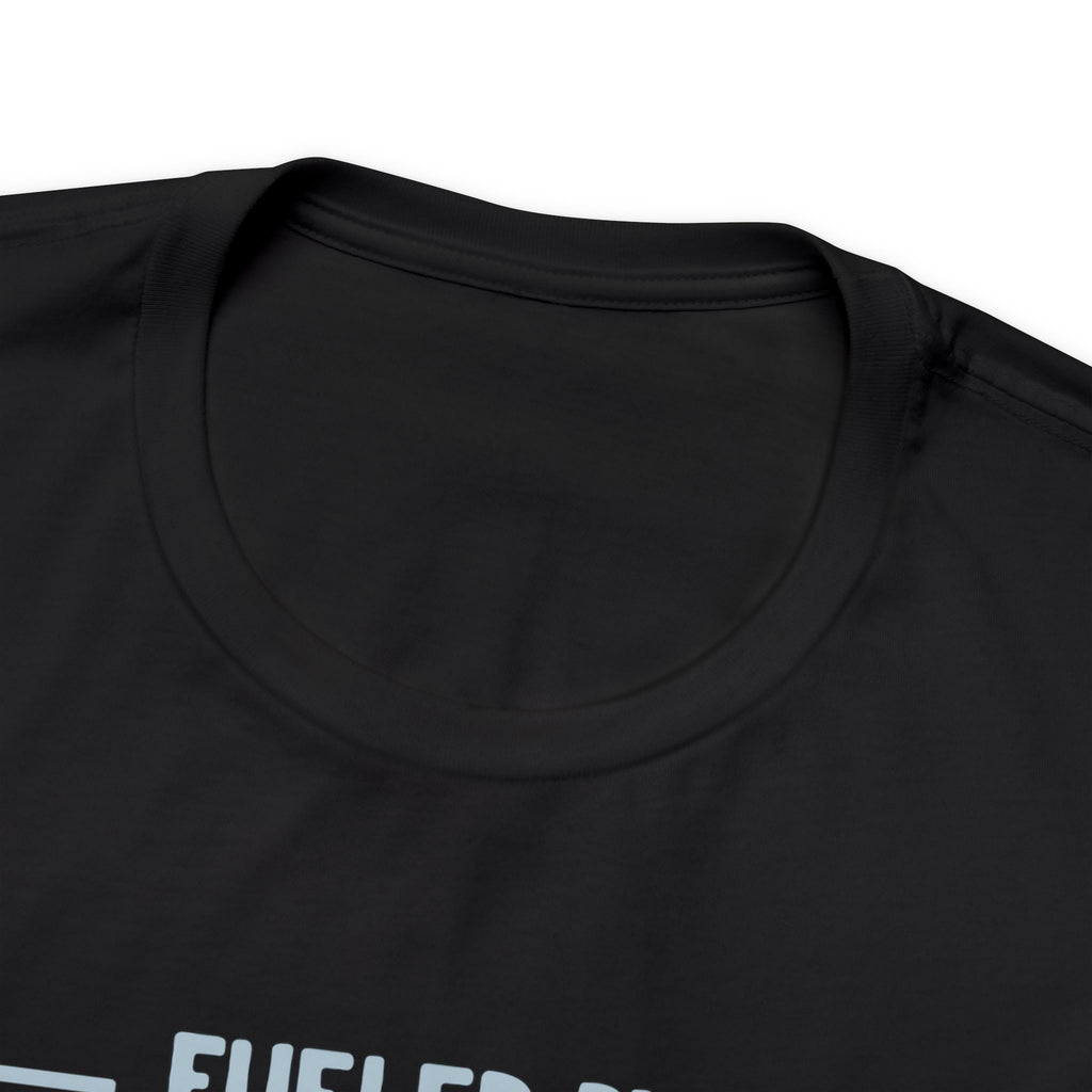 Close-up image of a black crew neck T-shirt highlighting the neckline and upper chest area, with the top portion of the “Fueled by Coffee and Dad Jokes” graphic partially visible, displayed against a plain white background.