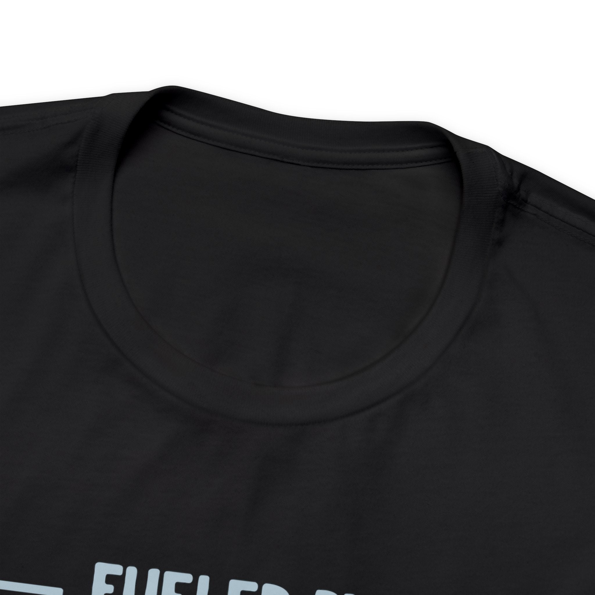 Close-up image of a black crew neck T-shirt highlighting the neckline and upper chest area, with the top portion of the “Fueled by Coffee and Dad Jokes” graphic partially visible, displayed against a plain white background.