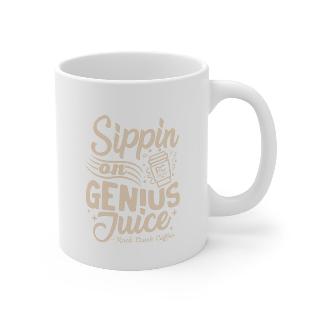 White ceramic Rock Creek Coffee mug featuring the phrase “Sippin on Genius Juice” in soft beige lettering with a small RC to go cup graphic on a clean white background.