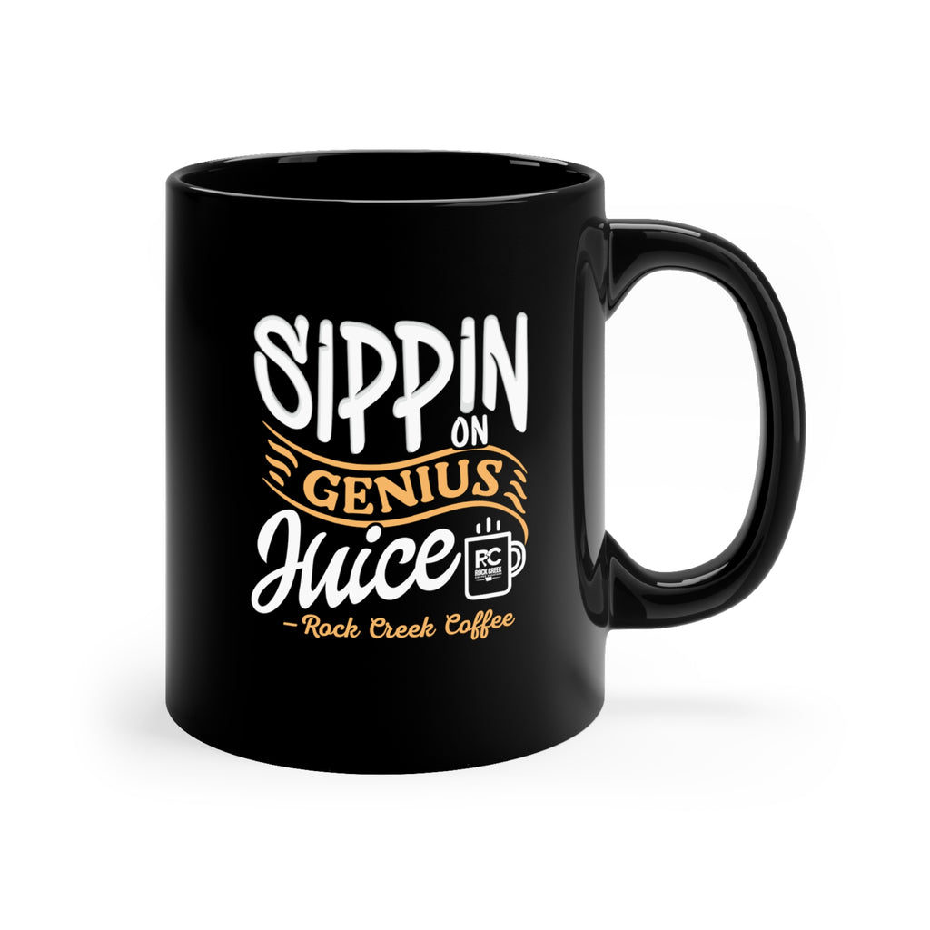 Black ceramic coffee mug with the phrase “Sippin on Genius Juice Rock Creek Coffee” in white and gold lettering, featuring a small RC coffee cup logo on a clean white background.