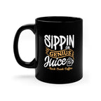 Black ceramic coffee mug with handle on the left featuring the phrase “Sippin on Genius Juice Rock Creek Coffee” in white and gold lettering with a small RC coffee cup logo on a clean white background.