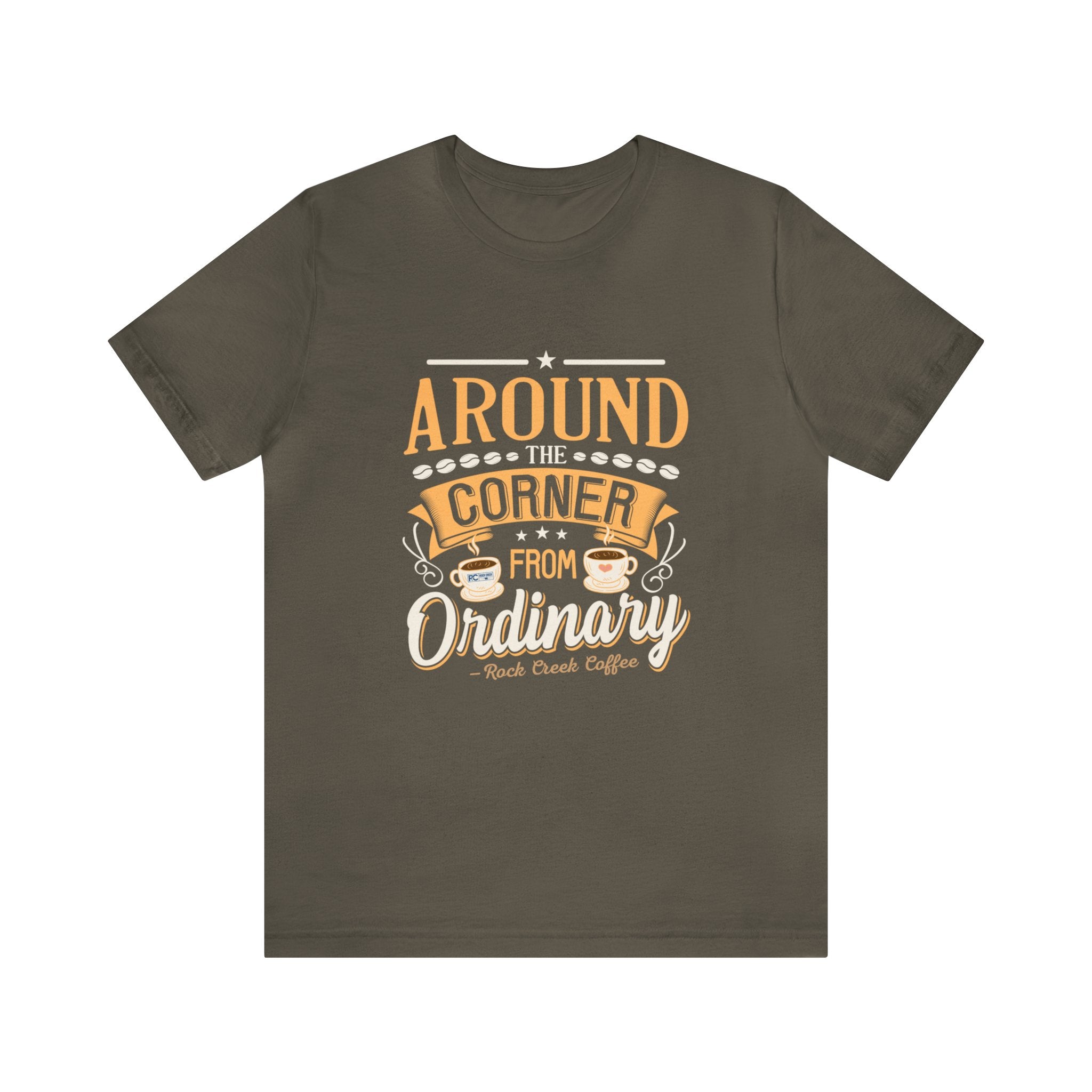 Army green short-sleeve T-shirt displayed flat against a plain white background, featuring the phrase “Around the Corner from Ordinary” in a bold coffee-themed typographic design with Rock Creek Coffee branding below.