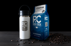 Rock Creek Coffee Roasters Ethiopian Ardi mild roast whole bean coffee bag displayed beside a white insulated travel tumbler with RC logo, with roasted coffee beans scattered on a dark tabletop against a black background.