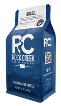 Rock Creek Coffee Roasters Brazil Porta Rossa medium roast whole bean coffee bag featuring notes of roasted nuts, chocolate, and honey, displayed against a clean white background.