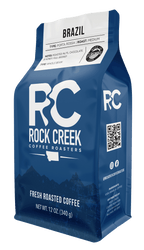 Rock Creek Coffee Roasters Brazil Porta Rossa medium roast whole bean coffee bag featuring notes of roasted nuts, chocolate, and honey, displayed against a clean white background.