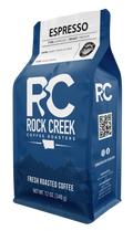 Rock Creek Coffee Roasters Espresso whole bean coffee in a blue 12 ounce bag featuring medium roast details and tasting notes of sweet syrup and citrus