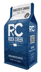 Rock Creek Coffee Roasters “Roaster’s Choice” whole bean coffee bag, 12 oz, featuring a blue package design with RC logo, customizable region and roast fields, and “Fresh Roasted Coffee” label.