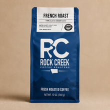 Load image into Gallery viewer, Rock Creek Coffee Roasters French Roast whole bean coffee bag standing upright on a soft beige studio background.