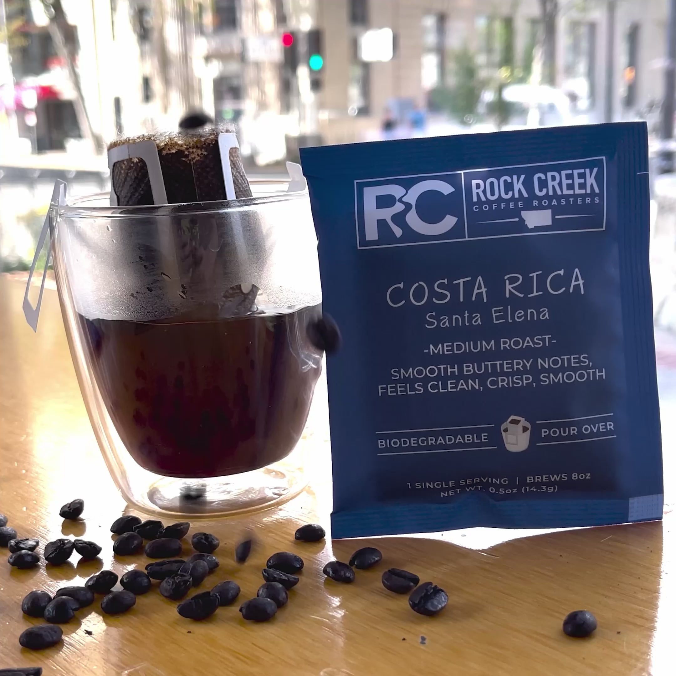 Close-up video of freshly roasted coffee beans tumbling and shifting in motion, highlighting their rich brown color, glossy surface, and textured cracks as they move together in a roaster.