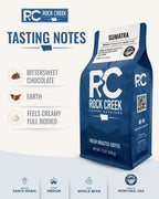 Rock Creek Coffee Roasters Sumatra dark roast coffee bag centered on a warm beige tasting notes graphic, with callouts for bittersweet chocolate, earth notes, and a creamy full-bodied profile, plus product details for Mandheling region, dark roast, and whole bean coffee.