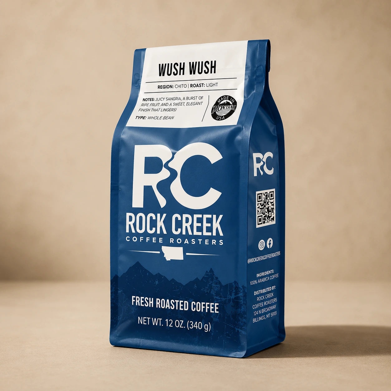 Rock Creek Coffee Roasters Wush Wush coffee bag standing upright on a warm neutral studio background.
